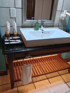 a bathroom with a sink and a counter with a towel at Grand Pool Villa Luxury Resort Port Dickson in Port Dickson
