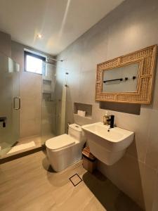 a bathroom with a toilet and a sink and a shower at Tahum Lake Resort in Los Baños