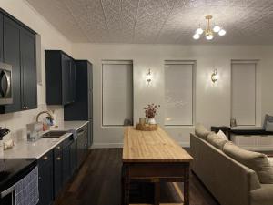 a kitchen with a table and a couch in it at Historic Market Plaza Overlook in Wheeling