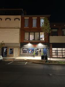 a store on the corner of a street at night at Historic Market Plaza Overlook in Wheeling
