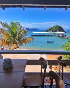 Casa entera en el Centro de Búzios - Paralela a la Rua das Pedras, zona premium y sin tránsito في بوزيوس: اطلالة على شاطئ مع طاولة وكراسي +76 صورة