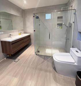 a bathroom with a shower and a toilet and a sink at Tahum Lake Resort in Los Baños +61 photos