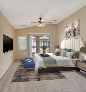 a bedroom with a large bed and a flat screen tv at nice home in Chandler