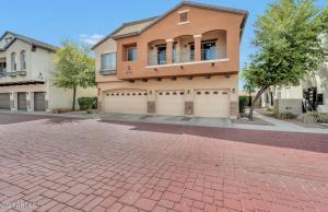 a house on a street with a brick driveway at nice home in Chandler