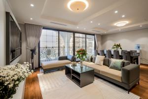 a living room with a couch and a table at Duc Hoang Residence West Lake in Hanoi