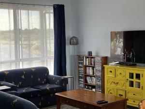 a living room with a couch and a table at Pelicans Perch in Mannum