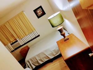 a bedroom with a bed and a lamp on a table at Golden Sunflower's Apt A in Lawton
