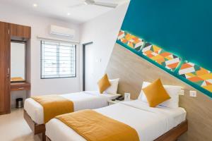 a hotel room with two beds and a staircase at Itsy By Treebo - Corner stay in Coimbatore