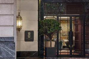 a door to a restaurant with a tree in front of it at The Ritz-Carlton, Kuala Lumpur in Kuala Lumpur