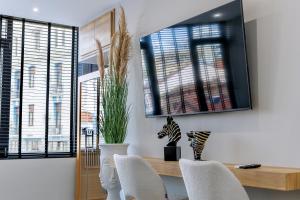 a dining room with a table and chairs and windows at Timeless luxury suites & SPA in Thessaloniki