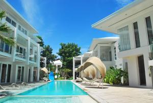 a swimming pool in front of a building at Astoria Boracay in Boracay