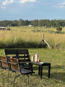 a picnic table and a bench in a field at Altos de Arenas in Miramar +3 photos