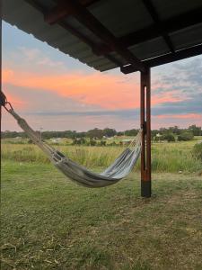 a hammock hanging from a pole in a field at Altos de Arenas in Miramar