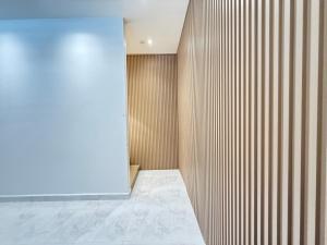a bathroom with a wooden wall and a door at relaxing home in Bukit Mertajam in Bukit Mertajam