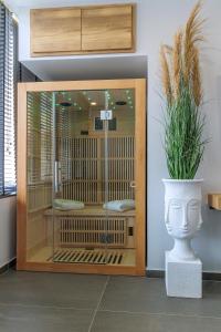 a glass door with a plant in a vase at Timeless luxury suites & SPA in Thessaloniki