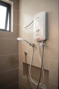 a shower in a bathroom with aitizer at Brand New Cozy Apartment 4BR9Pax in Bukit Mertajam