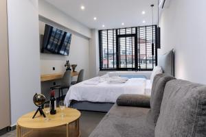 a living room with a bed and a couch at Timeless luxury suites & SPA in Thessaloniki