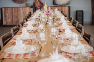 a long table with white plates and wine glasses at Tropical Castle Villa in Phuket +33 photos