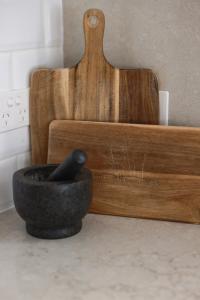 a wooden chair sitting next to a black bowl at Firefly Cottage in Mount Tamborine