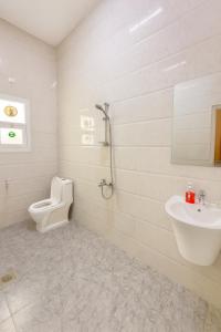 a bathroom with a toilet and a sink at Abu Rakan Apartment in Muscat