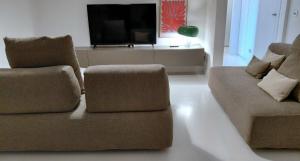 a living room with two couches and a flat screen tv at Villa Maria in Onno