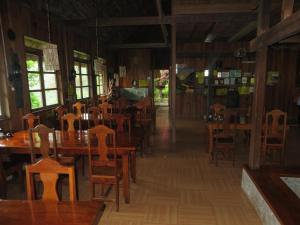 a dining room with wooden tables and chairs at Native Village Inn in Banaue