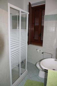 een badkamer met een toilet, een wastafel en een bad bij Casa Vacanza Don Matteo in Villafranca Tirrena