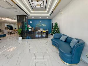 a living room with a blue couch and a christmas tree at The Answer Hotel in Ao Nang Beach