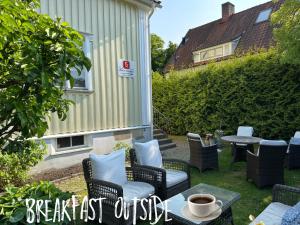 a patio with chairs and a table with a cup of coffee at 5:ans Bed & Breakfast in Gothenburg