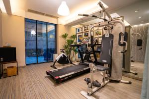 a fitness room with a treadmill and a gym at H-hotel Riverside in Chengdu