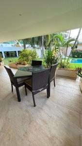 a patio with a table and chairs and plants at Villa Sun 2 in Amphoe Koh Samui