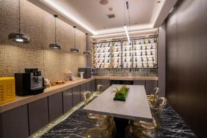 a restaurant with a table and chairs in a room at H-hotel Riverside in Chengdu