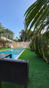 a swimming pool with green grass next to a building at Villa Sun 2 in Amphoe Koh Samui