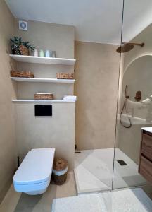 a bathroom with a toilet and a glass shower at Apartment front line in Moraira +20 photos