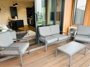 a living room with two chairs and a table at Lakewood Apartment in Cambridge