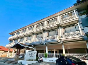 a building with a scooter parked in front of it at Serenity by Peace Garden in Amphoe Koh Samui