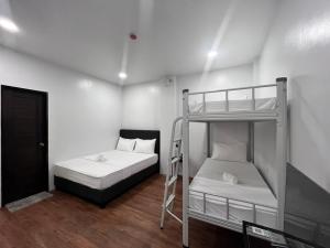 a bedroom with two bunk beds and a ladder at 20 Boeing Apt in Manila