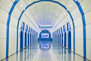 an empty hallway in a building with blue and white walls at ART Hostel in Almaty