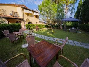 a patio with a table and chairs and an umbrella at Cascina De' Fagiolari in Lastra a Signa