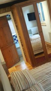 a bedroom with a door leading to a bed at Edwardian Apartment Garden Flat in London