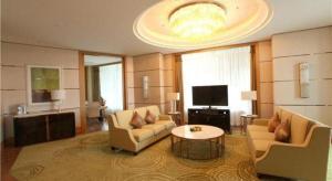 a living room with two couches and a television at Dusit D2 Binhu Changzhou Hotel in Changzhou
