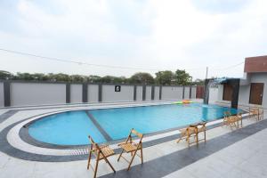a swimming pool on top of a building at Samyukta resort in Gogāpur +5 photos