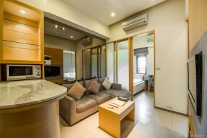 a living room with a couch and a table at 謙匯國際酒店式公寓 CH Service Apartment in Taipei