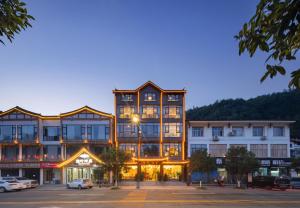 a large building in the middle of a street at Zhangjiajie Oxygen Lodge in Zhangjiajie
