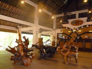 a room with a table and some wooden furniture at Can Gio Resort in Ấp Long An