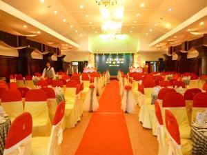 a banquet hall with red and white tables and chairs at Can Gio Resort in Ấp Long An +161 photos