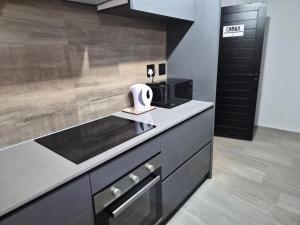 a kitchen with a counter with a sink and a microwave at Coastal Cove in Cape Town