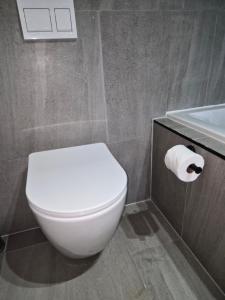 a bathroom with a white toilet and a sink at Coastal Cove in Cape Town +1 photo