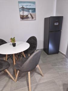 a dining room with a table and a refrigerator at Coastal Cove in Cape Town