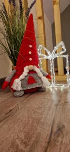 a small red gnome sitting on top of a table at Domek na Folwarku z jacuzzi in Tarnawa Dolna